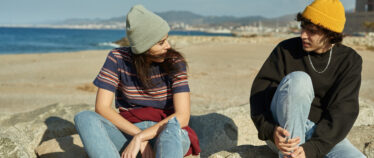 Young man and young woman seated and having a conversation