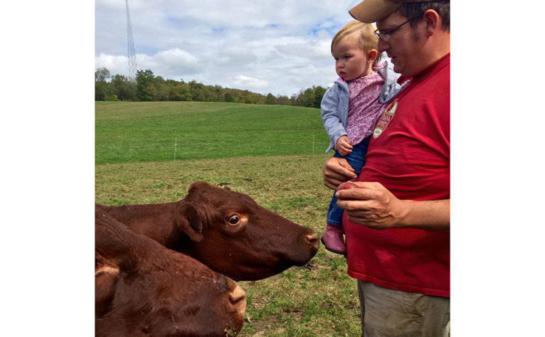 Charles with baby and cows