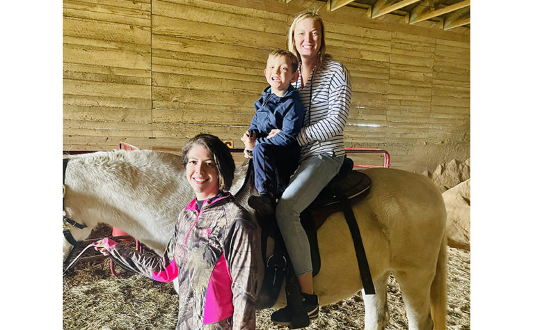 Jessie leading horse on family ride